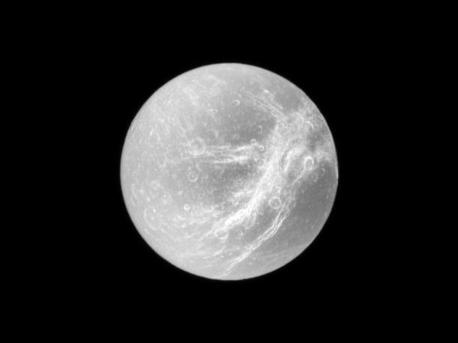 Appearing like the swirls of marble, the wispy terrain of Saturn's moon Dione is captured in a dramatic display of light and dark. These wispy features are a system of braided canyons with bright walls. This view looks toward the area between the trailing hemisphere and Saturn-facing side of Dione (1,123 kilometers, or 698 miles across). North on Dione is up and rotated 1 degree to the left. The image was taken in visible light with the Cassini spacecraft narrow-angle camera on Dec. 26, 2009. The view was acquired at a distance of approximately 644,000 kilometers (400,000 miles) from Dione and at a Sun-Dione-spacecraft, or phase, angle of 2 degrees. Image scale is 4 kilometers (2 miles) per pixel.