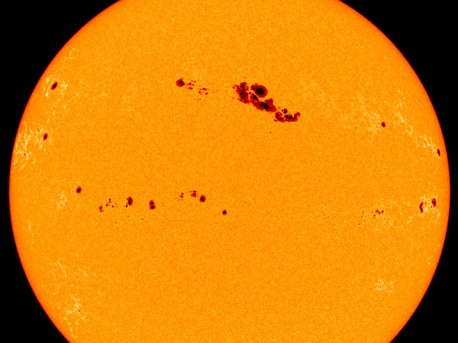 The spacecraft SOHO (Solar and Heliospheric Observatory) took this picture of the Sun's surface, showing an unusually large number of sunspots, in March 2001. Sunspots are caused by differences in temperature on the Sun's surface: cooler points appear as black spots.