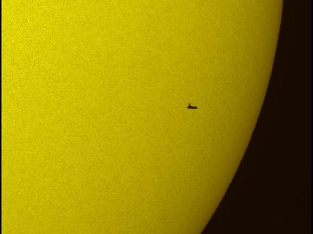 In this tightly cropped image, the NASA space shuttle Atlantis is seen in silhouette during solar transit, Tuesday, May 12, 2009, from Florida. This image was made before Atlantis and the crew of STS-125 had grappled the Hubble Space Telescope.
