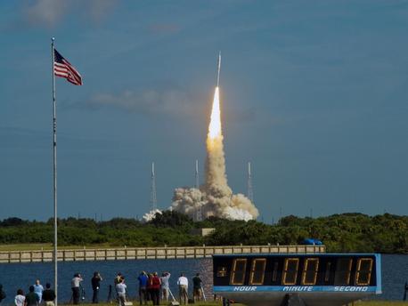 The stars and stripes on the American flag reflect NASA's commitment to teamwork as the Constellation Program's Ares I-X test rocket roars off Launch Complex 39B at NASA's Kennedy Space Center in Florida. 