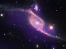 This composite image of data from three different telescopes shows an ongoing collision between two galaxies, NGC 6872 and IC 4970. X-ray data from NASA's Chandra X-ray Observatory is shown in purple, while Spitzer Space Telescope's infrared data is red and optical data from ESO's Very Large Telescope (VLT) is colored red, green and blue.