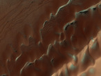 Dunes are often found on crater floors. In the winter time at high northern latitudes the terrain is covered by carbon dioxide ice (dry ice). In the spring as this seasonal ice evaporates many unusual features unique to Mars are visible.