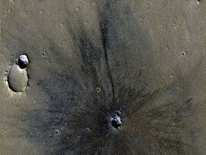 This image shows a very fresh-looking impact crater with extensive radial ejecta.

The crater was first seen in an image acquired with MRO's Context Camera (CTX). The best image of this region prior to CTX was from one of the Viking Orbiters, and the crater isn't apparent in that image. This could mean that the crater formed sometime between 1976 and 1999, or there may have been more dust on the surface in 1976 or the air may have been hazy, obscuring the crater.