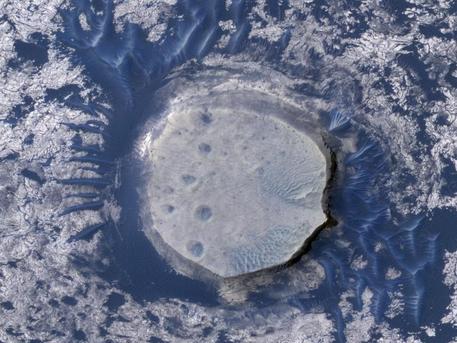 This view of an inverted crater in the Arabia Terra region of Mars is among the images taken by NASA's Mars Reconnaissance Orbiter in early 2010 as the spacecraft approached the 100-terabit milestone in total data returned.