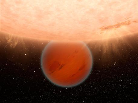 An unusual, methane-free world is partially eclipsed by its star in this artist's concept. NASA's Spitzer Space Telescope has found evidence that a hot, Neptune-sized planet orbiting a star beyond our sun lacks methane -- an ingredient common to many planets in our own solar system.