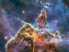 This craggy fantasy mountaintop shrouded by wispy clouds looks like a bizarre landscape from Tolkien’s The Lord of the Rings. The NASA/ESA Hubble Space Telescope image, which is even more dramatic than fiction, captures the chaotic activity atop a pillar of gas and dust, three light-years tall, which is being eaten away by the brilliant light from nearby bright stars. The pillar is also being assaulted from within, as infant stars buried inside it fire off jets of gas that can be seen streaming from towering peaks.
