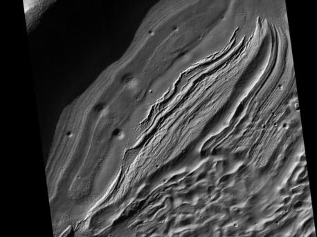 This subimage from an observation by the High Resolution Imaging Science Experiment (HiRISE) camera on NASA's Mars Reconnaissance Orbiter covers a small portion of the northwest quadrant of Hellas Basin, or Hellas Planitia, on southern Mars. With a diameter of about 2,200 kilometers (about 1,400 miles) and a depth reaching the lowest elevations on Mars, Hellas is one of the largest impact craters in the solar system.
This area of Hellas Basin has a number of unusual features which are thought to be quite old because of the high crater density. Here a crater inside Hellas has been filled with material. This may be related to volcanic activity on the northwestern rim of Hellas.
However, it might also be related to water and water ice. There is evidence elsewhere that the ground here is ice-rich. HiRISE is being used to investigate this in more detail when Hellas Basin is free from atmospheric dust.