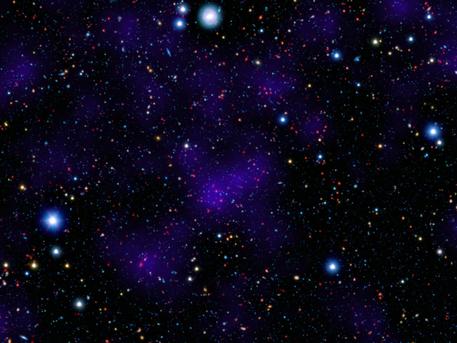A surprisingly large collection of galaxies (red dots in center) stands out at a remarkably large distance in this composite image combining infrared and visible-light observations. NASA's Spitzer Space Telescope contributed to the infrared component of the observations, while shorter-wavelength infrared and visible data are provided by Japan's Subaru telescope atop Mauna Kea, Hawaii.
Looking out to this distance, the cluster appears as it was 9.6 billion years ago, only about three billion years after the Big Bang. Astronomers were surprised to find such a "modern" cluster at an era when its peers tended to be much smaller, presumably taking billions of more years to collect enough galaxies to reach such a size.
