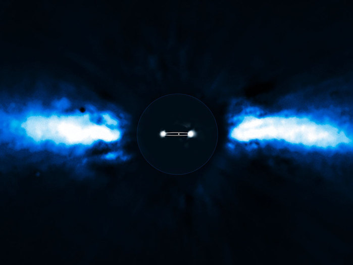 For the first time, astronomers have been able to directly follow the motion of an exoplanet as it moves to the other side of its host star. The planet has the smallest orbit so far of all directly imaged exoplanets, lying as close to its host star as Saturn is to the Sun.

The team of astronomers used the NAOS-CONICA instrument (or NACO), mounted on one of the 8.2-metre Unit Telescopes of ESO's Very Large Telescope (VLT), to study the immediate surroundings of Beta Pictoris in 2003, 2008 and 2009. In 2003 a faint source inside the disc was seen, but it was not possible to exclude the remote possibility that it was a background star. In new images taken in 2008 and spring 2009 the source had disappeared! The most recent observations, taken during autumn 2009, revealed the object on the other side of the disc after having been hidden either behind or in front of the star. This confirmed that the source indeed was an exoplanet and that it was orbiting its host star. It also provided insights into the size of its orbit around the star.

The above composite shows the reflected light on the dust disc in the outer part, as observed in 1996 with the ADONIS instrument on ESO's 3.6-metre telescope. In the central part, the observations of the planet obtained in 2003 and autumn 2009 with NACO are shown. The possible orbit of the planet is also indicated, albeit with the inclination angle exaggerated.