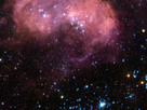 This broad vista of young stars and gas clouds in our neighbouring galaxy, the Large Magellanic Cloud, was captured by the NASA/ESA Hubble Space Telescope’s Advanced Camera for Surveys (ACS). This region is named LHA 120-N 11, informally known as N11, and is one of the most active star-forming regions in the nearby Universe. This picture is a mosaic of ACS data from five different positions and covers a region of about 6 arcmin across.
