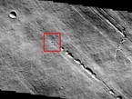 The small round black spot in this THEMIS image may be a hole in the roof of a Martian lava tube or cave.