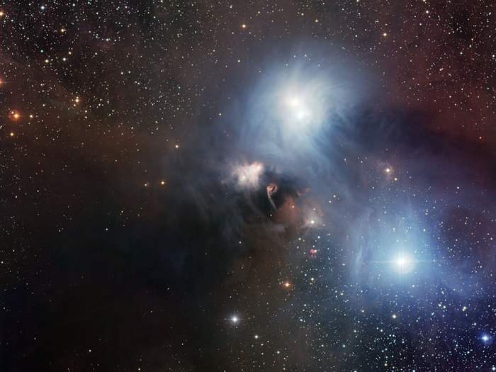 The nearby star-forming region around the star R Coronae Australis imaged by the Wide Field Imager (WFI) on the MPG/ESO 2.2-metre telescope at ESO’s La Silla Observatory in Chile. This picture, which covers a field of 33.7 x 31.9 arcminutes (about the diameter of the full Moon), is a combination of twelve CCD frames, 67 megapixels each, taken through B, V and R filters, with four exposures of five minutes each.