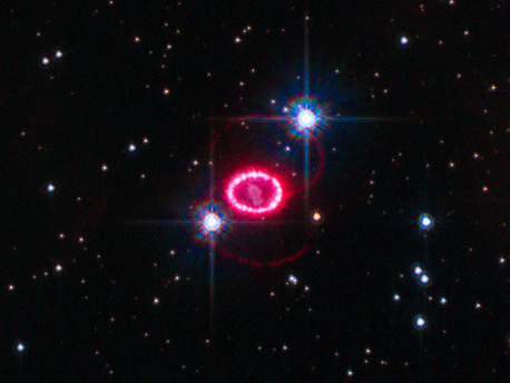 This image shows the entire region around supernova 1987A. The most prominent feature in the image is a ring with dozens of bright spots. A shock wave of material unleashed by the stellar blast is slamming into regions along the ring's inner regions, heating them up, and causing them to glow. The ring, about a light-year across, was probably shed by the star about 20,000 years before it exploded.