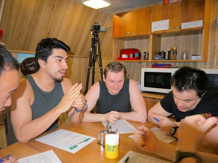 The psychological issues are mapped with different kinds of questionnaires. Mars500 crew has gathered around the big table to fill one of the forms.
