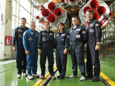 At the Baikonur Cosmodrome in Kazakhstan, the prime and backup crews to join Expedition 24 on the International Space Station pose for a picture in front of their Soyuz booster rocket in its integration building June 11, 2010. From left to right are prime crew members Doug Wheelock, Soyuz Commander Fyodor Yurchikhin and Shannon Walker, with backup crew members Cady Coleman, Dmitri Kondratiev and Paolo Nespoli of the European Space Agency. Wheelock, Yurchikhin and Walker will launch next week in the Soyuz TMA-19 spacecraft on a two-day trip to the International Space Station.