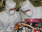 Image shows Grad student Nicholas Boyd (left) and Principal Investigator Ralf Gellert, both of the University of Guelph, Ontario, Canada, preparing for the installation of the sensor head on the Alpha Particle X-ray Spectrometer instrument during testing at NASA's Jet Propulsion Laboratory.The instrument is part of the Curiosity rover, which will fly on NASA's Mars Science Laboratory mission. The sensor head is 7.8 centimeters, or about 3 inches tall.
