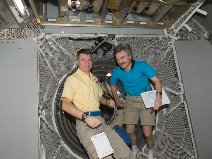 ESA astronaut Paolo Nespoli (top) and Russian cosmonaut Alexander Kaleri, both Expedition 26 flight engineers, work in the newly-attached ESA's ATV Johannes Kepler of the International Space Station. NASA photo iss026e029705. 
