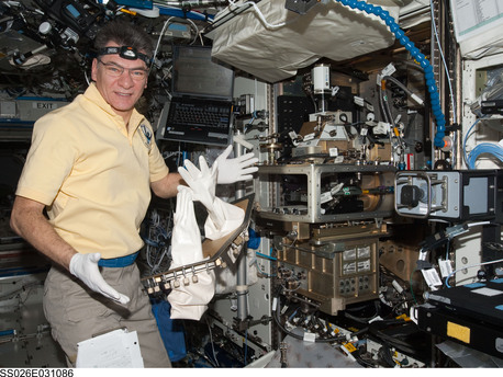ESA astronaut Paolo Nespoli, Expedition 26 flight engineer, works on 1 March 2011 with the Light Microscopy Module (LMM) Spindle Bracket Assembly in the Fluids Integrated Rack (FIR) in the Destiny laboratory of the International Space Station.