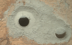 At the left of this image from NASA's Curiosity rover is the hole in a rock called "John Klein" where the rover conducted its first sample drilling on Mars. Image credit: NASA/JPL-Caltech/MSSS