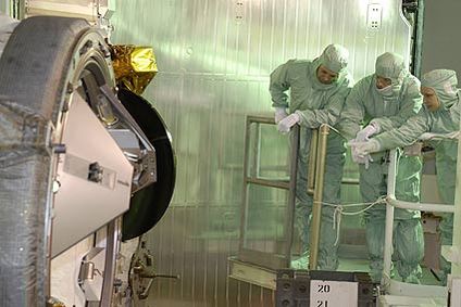 STS-119 crew members get a close look at the docking adapter installed in space shuttle Discovery's payload bay. 