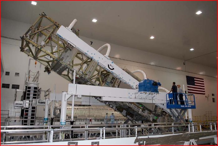 Boeing workers stand ready as the starboard integrated truss is rotated in order to remove and replace lower
deck batteries.