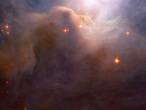 This close-up of an area in the northwest region of the large Iris Nebula seems to be clogged with cosmic dust. With bright light from the nearby star HD 200775 illuminating it from above, the dust resembles thick mounds of billowing cotton. It is actually made up of tiny particles of solid matter, with sizes from ten to a hundred times smaller than those of the dust grains we find at home. Both background and foreground stars are dotted throughout the image. Researchers studying the object are particularly interested in the region to the left and slightly above center in the image, where dusty filaments appear redder than is expected.