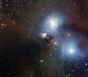 This pan shows many details in a gorgeous cosmic watercolour of the star-forming region around the star R Coronae Australis that was captured by the Wide Field Imager (WFI), on the MPG/ESO 2.2-metre telescope at ESO’s La Silla Observatory. Fine details of the bluish reflection nebula and the huge surrounding dust cloud are visible. This star-forming region is located some 420 light-years away in the small constellation of Corona Australis (the Southern Crown).